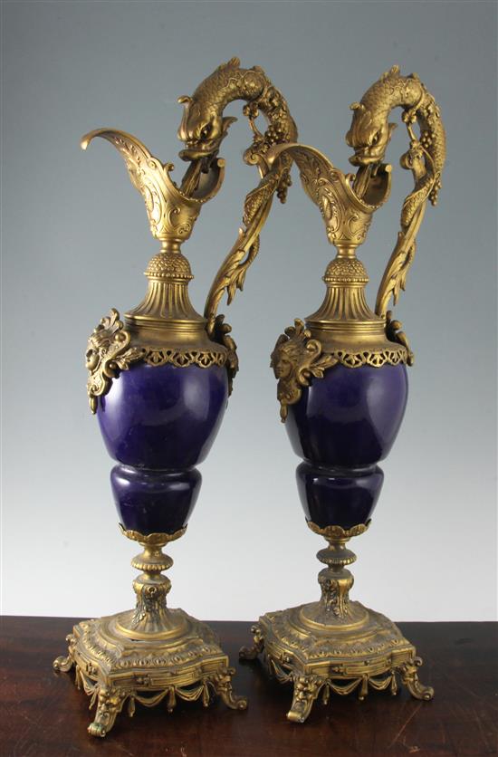 A pair of French ormolu mounted blue glazed porcelain ewers, H.25in.